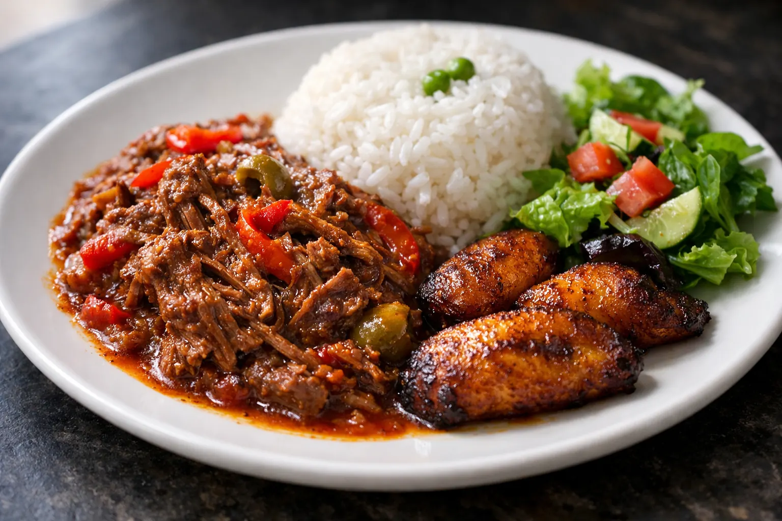 Plate of ropa vieja with white rice, sweet plantains and salad